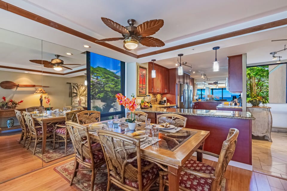 Dining area with wooden table and cushioned chairs set in an open-concept space.