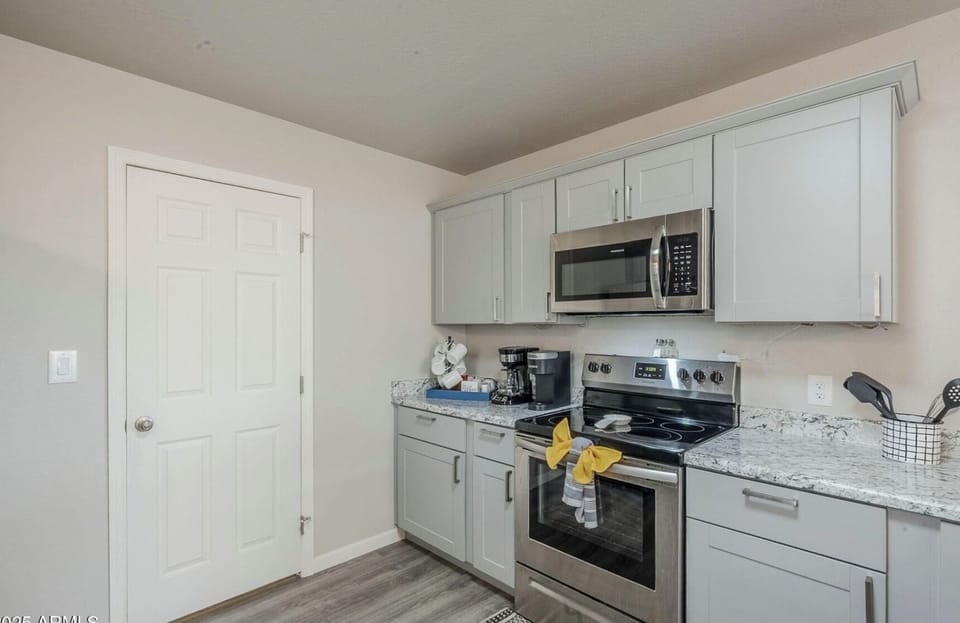 Two coffee makers, stove, oven and microwave.
