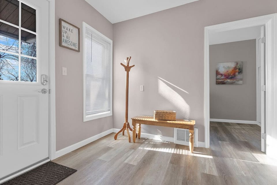 This sunlit nook with a bench offers a calm spot to get ready or simply enjoy the view outside.