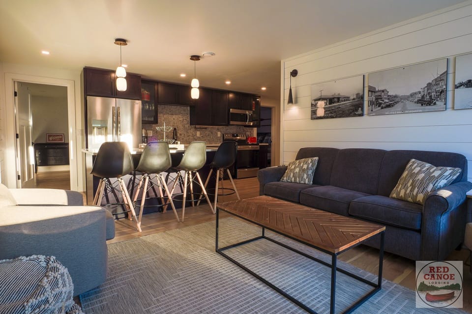 Inviting open-concept living room flowing seamlessly into the kitchen — ideal for gathering and relaxing after a day by the lake.