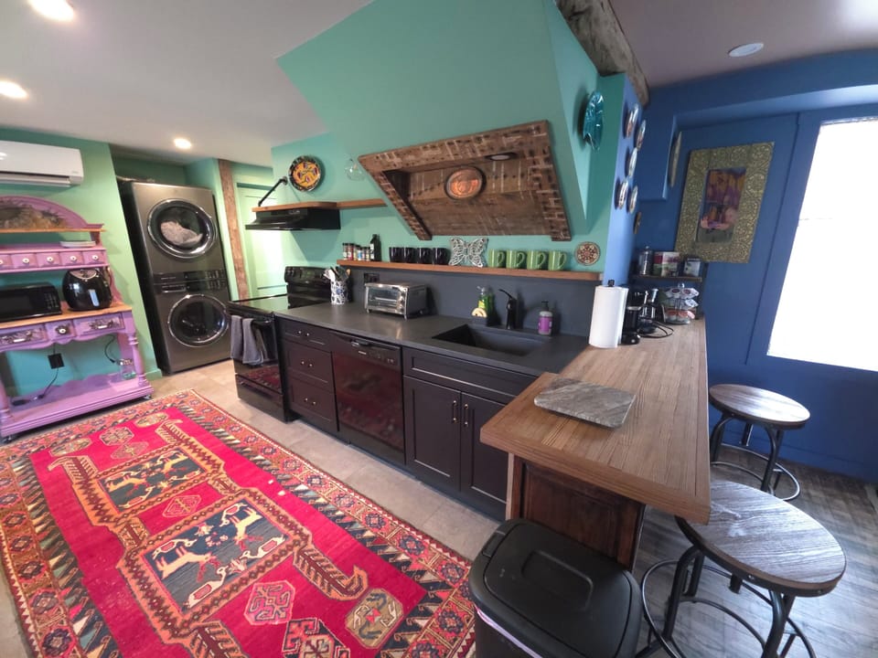 Enjoy the open kitchen living space, coffee and tea bar. Full size laundry. 