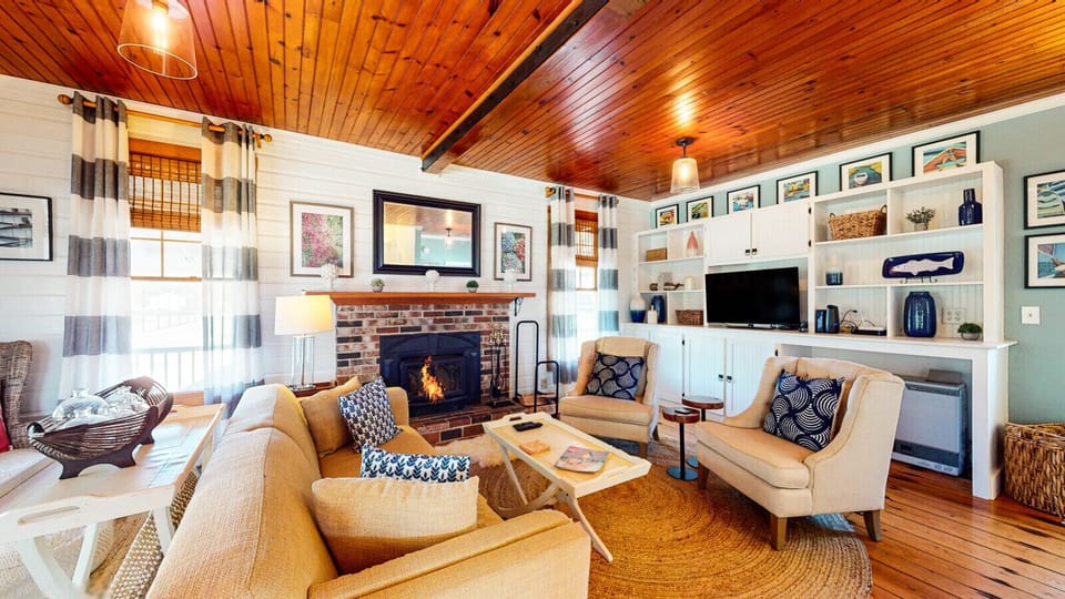 Main house living room with wood burning fireplace