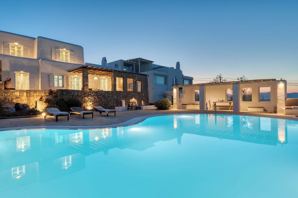 Private pool with sunbeds and a shaded lounge area by Villa Zanetti