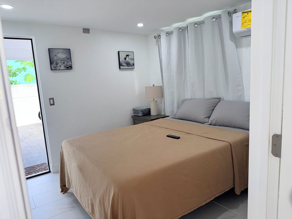 Queen bedroom 2 -Step into your peaceful bedroom sanctuary where crisp linens and gentle natural light create the perfect retreat. Relax in your comfortable bed while enjoying views of the sunny patio beyond.  Closet to the right of bed