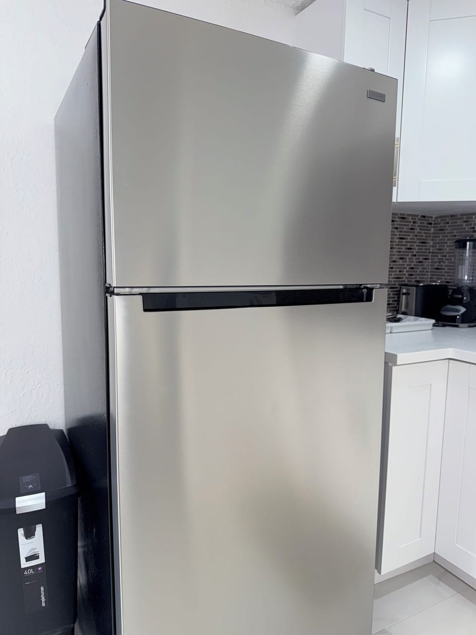 Step into your modern kitchen sanctuary with sleek stainless steel appliances and pristine white cabinetry. You'll love preparing meals with professional-grade amenities at your fingertips.