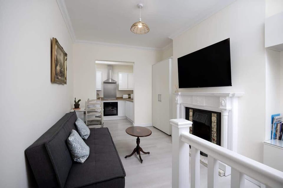 “Simple and minimalist living room designed for comfort — perfect for relaxing after a day out in the city.”