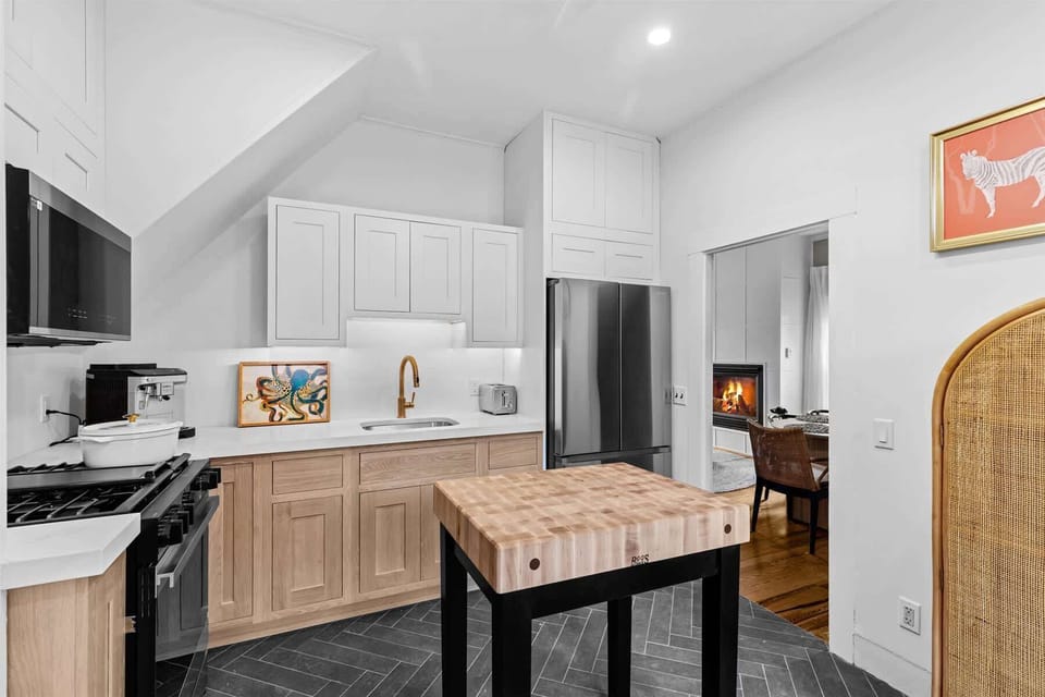 A spacious kitchen layout offers generous counter space, premium stainless steel appliances, and timeless coastal design.