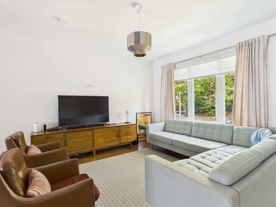 Spacious living room designed for connection — unwind with a movie night or morning coffee bathed in natural light.