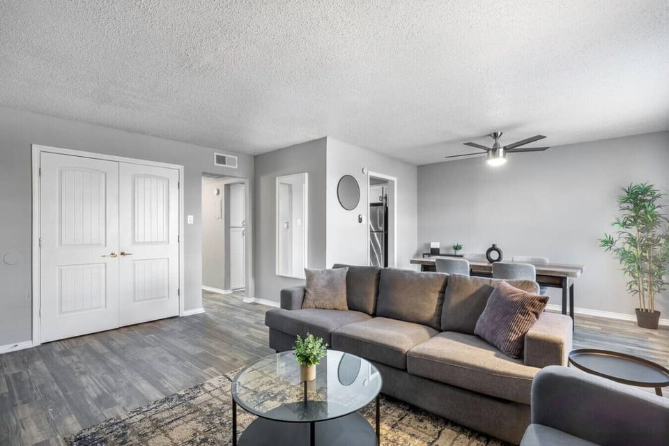 Spacious and inviting living area with comfortable seating and a smart TV, perfect for relaxing after exploring Arlington or attending events at AT&T Stadium.
