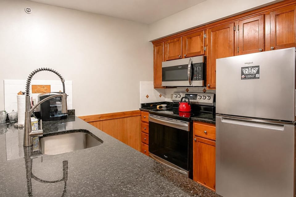 Prepare meals or quick bites with ease in the fully equipped kitchen.