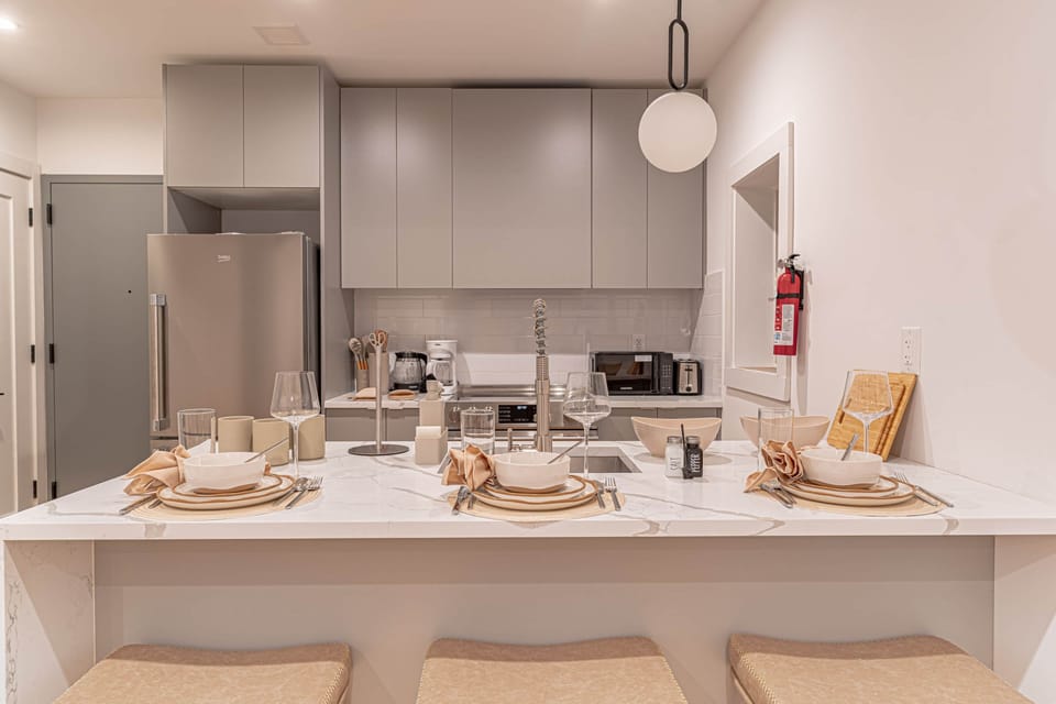 Sleek kitchen and dining area with ample counter space, perfect for dinners and brunches at home.