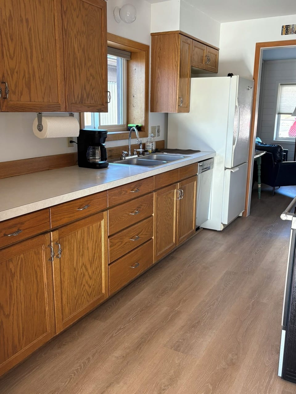 Kitchen with new appliances and flooring.