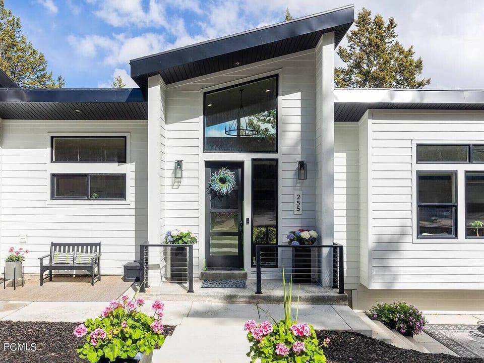 Modern exterior with big windows and a quiet spot to sit out front.