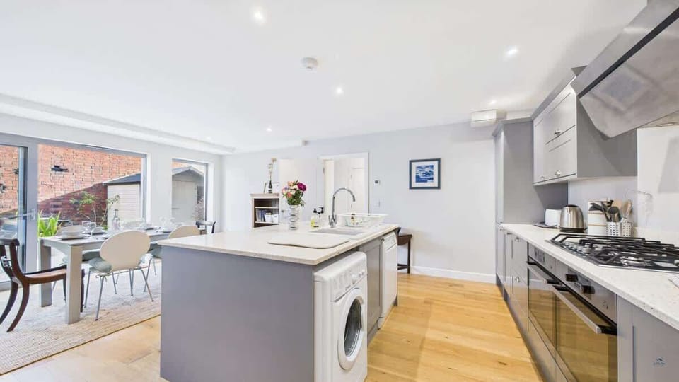 This conscious-living kitchen is fully equipped with integrated appliances and premium finishes.
