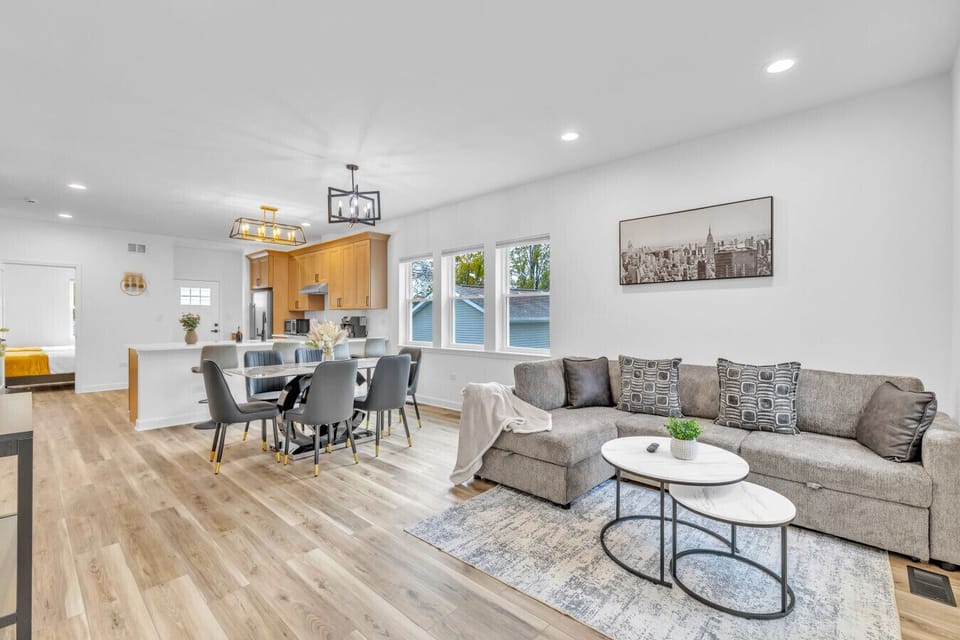 Spacious open layout featuring a cozy living area, dining space, and fully equipped kitchen