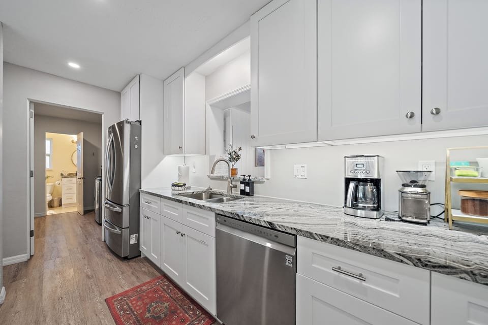 Make the most of the modern convenience of a dishwasher, fridge, stove, and microwave in this fully-furnished kitchen.