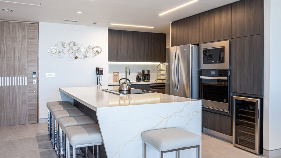 Kitchen island, appliances including wine fridge.