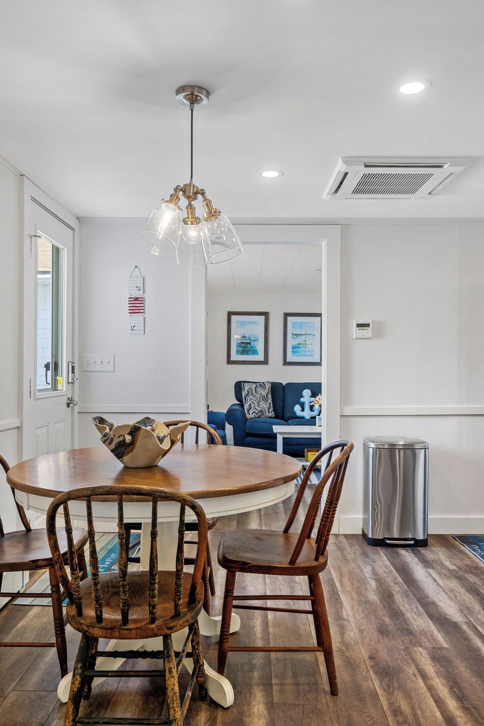 Charming dining area with a cozy round table—perfect for family meals, morning coffee, or planning your next beach day, all in a bright and inviting coastal setting.