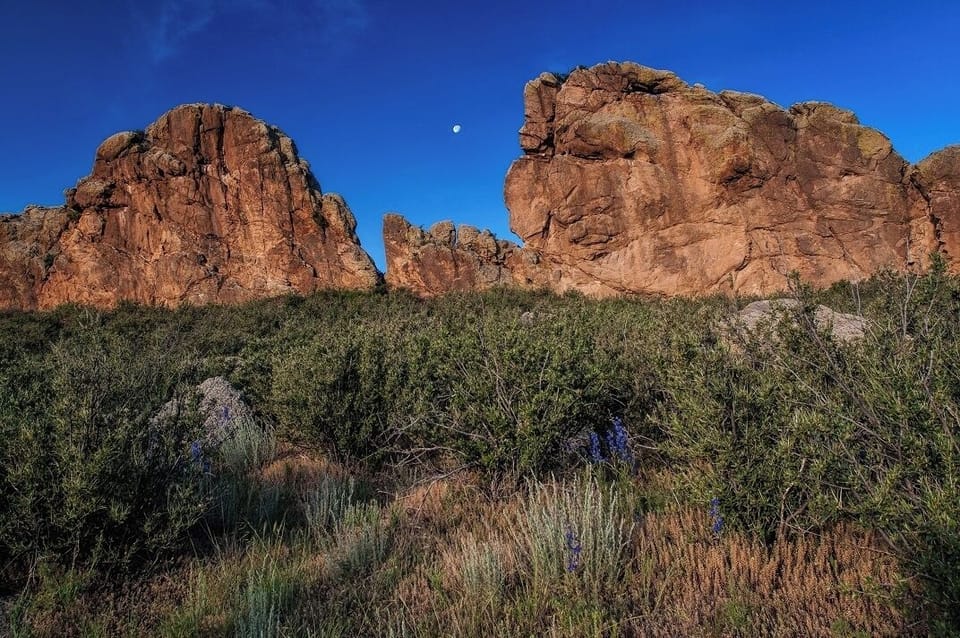 Explore dramatic local rock formations under wide, blue skies.