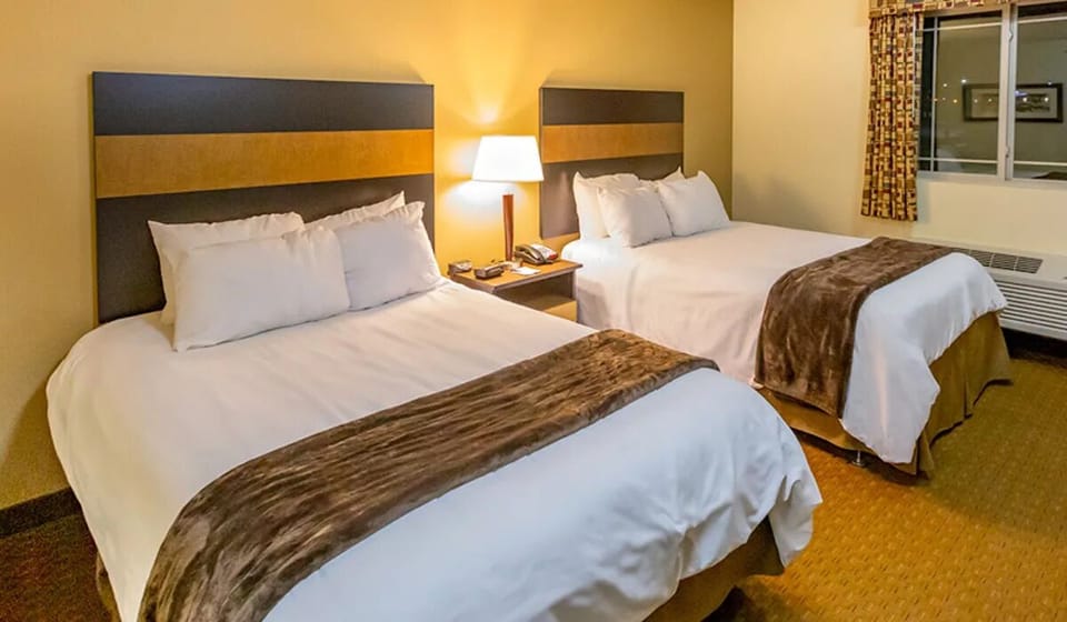 Stretch out with extra space around two freshly made beds.