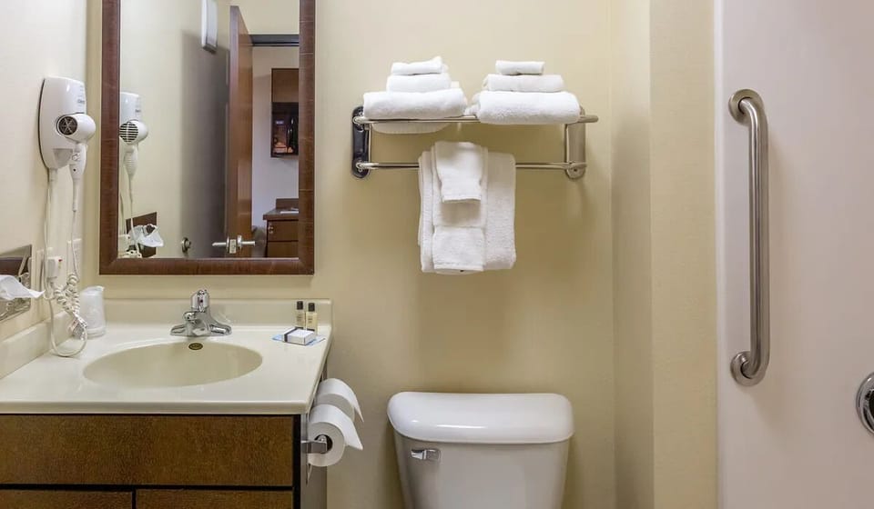 Refresh comfortably with bright vanity lighting and plush towels.