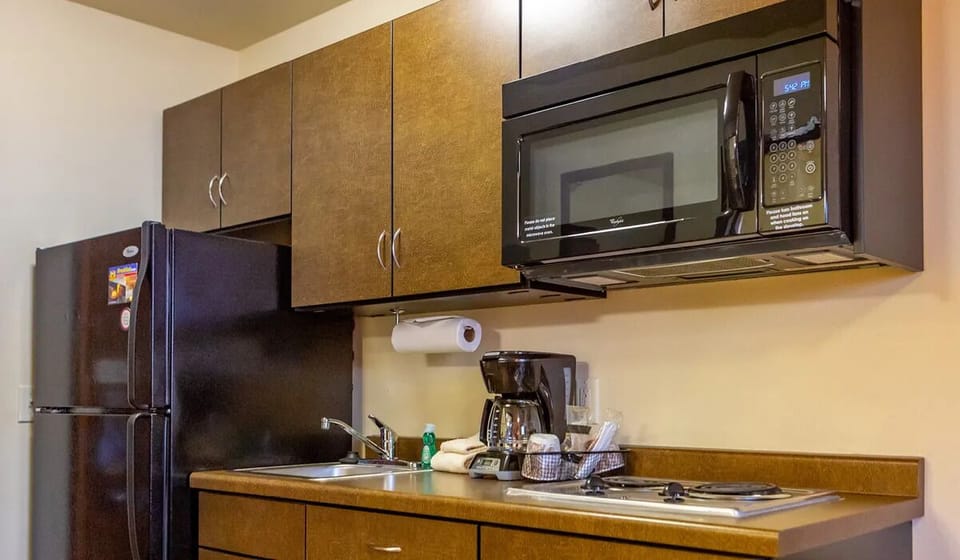 Cook simple meals easily with full fridge and microwave.