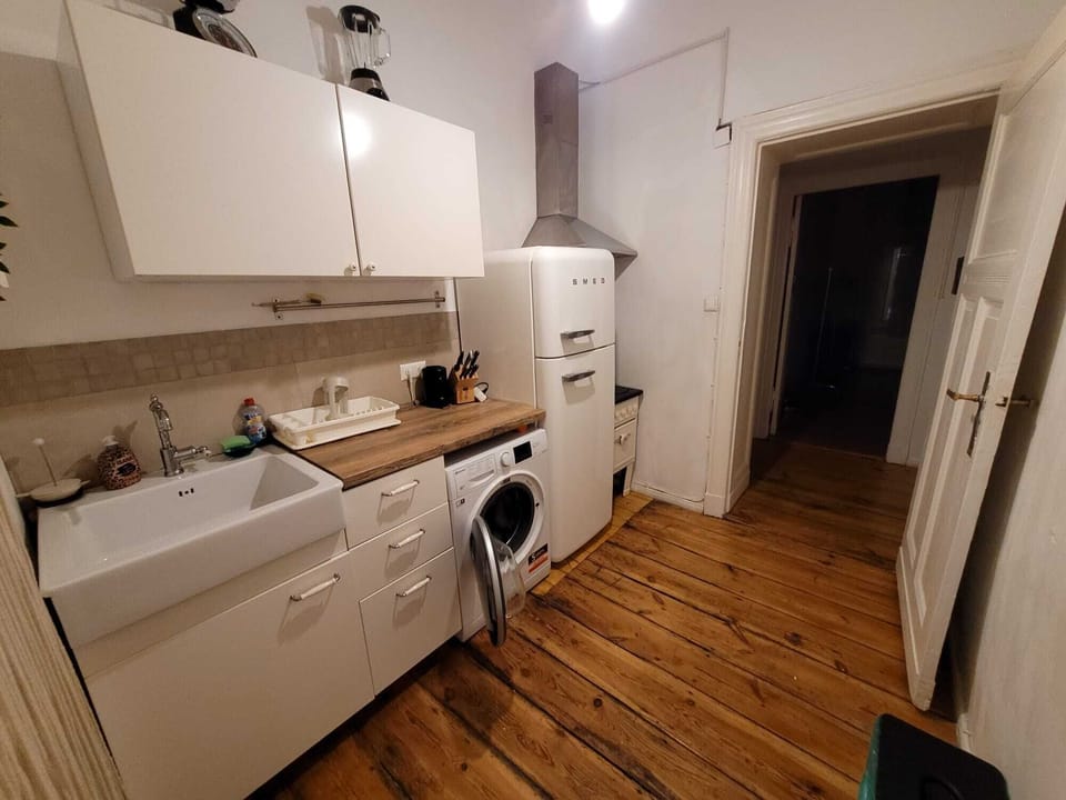 Cozy kitchen with farmhouse sink, SMEG fridge, and all essentials.