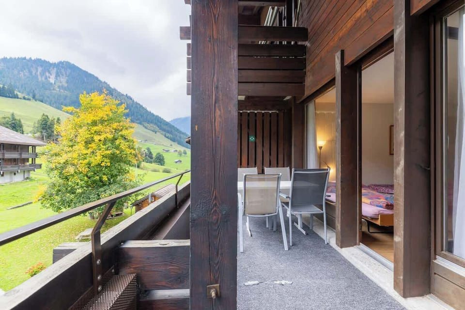Balcony with outdoor seating and green surroundings