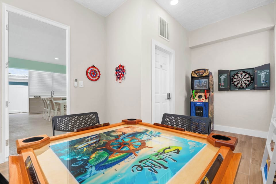 Arcade + darts + domino table = game night locked in. This room keeps the competition going while everyone else chills by the pool.