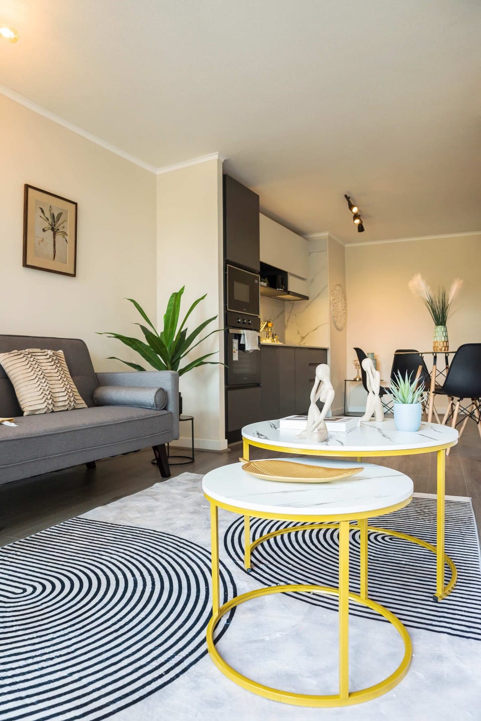 Chic and cozy living space with modern decor and a fully equipped kitchen, perfect for a relaxing stay.