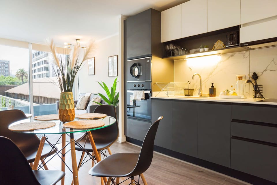 Stylish kitchen and dining area with modern amenities and abundant natural light, perfect for cozy meals.