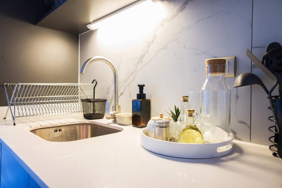 Sleek and modern kitchen space with stylish fixtures and ample lighting, perfect for preparing meals.