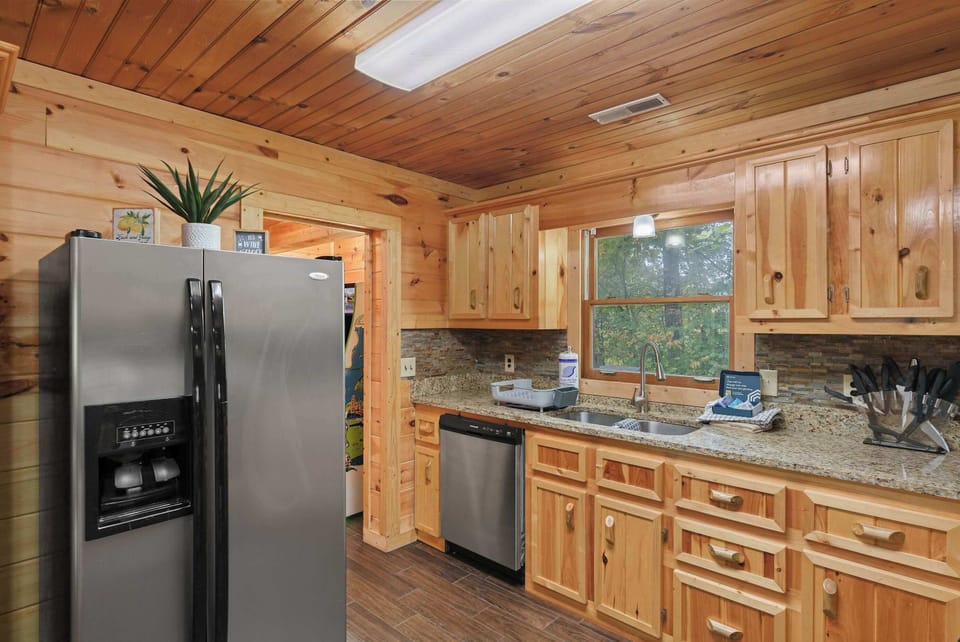 Bright granite counters and wooden accents create a delightful cooking haven!