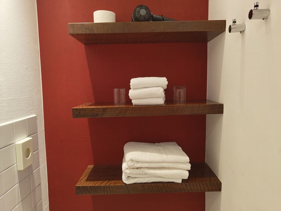 Modern Bathroom with Towels, Hairdryer and Body Soap