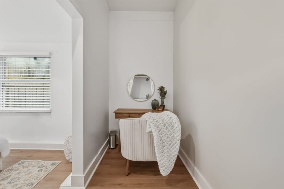 A charming vanity nook offers the perfect spot to get ready for dinner or unwind with a quiet moment.