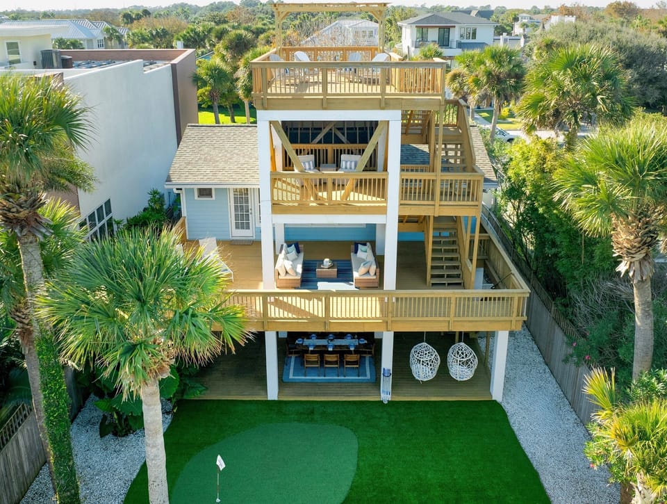 Three levels of coastal living — rooftop views, shaded balconies, and a private putting green below. 🌴✨