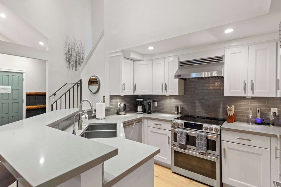 Gourmet kitchen with stainless steel appliances and stone counters!