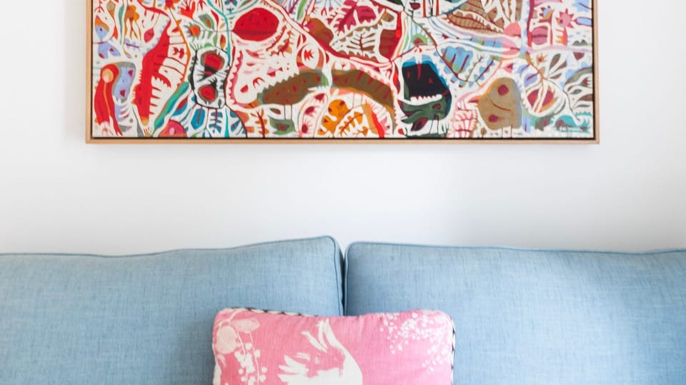 Cozy sofa with colourful artwork