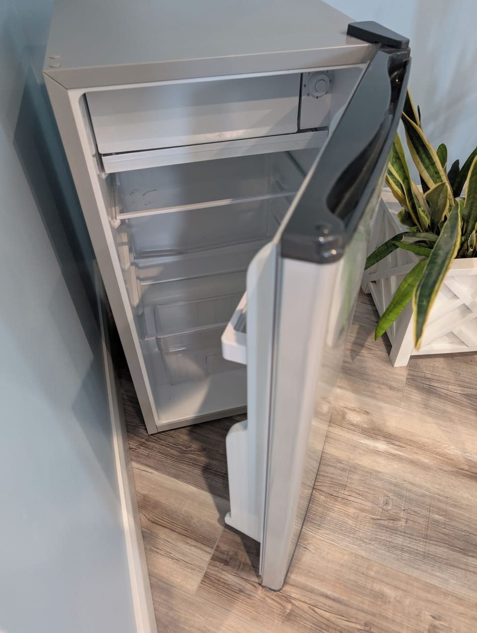 Mini refrigerator for additional beverage storage.