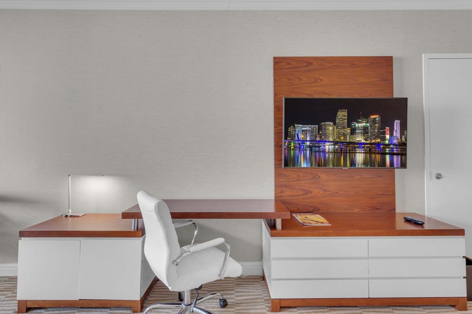 Suite with king bed, sofa sleeper, Smart TV, and work space 