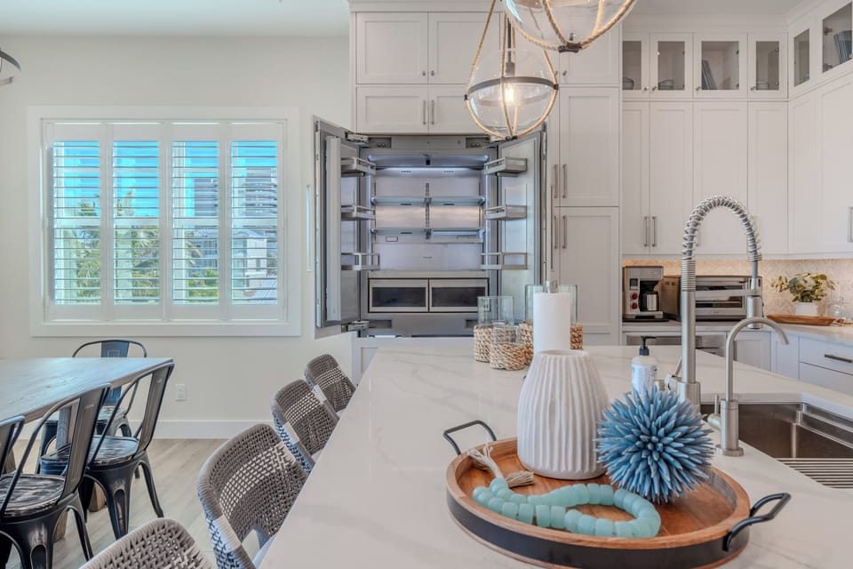 Bright and welcoming breakfast bar with modern fridge and appliances.