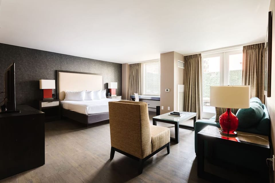 Unwind in this sunlit suite with lounge seating and king bed.