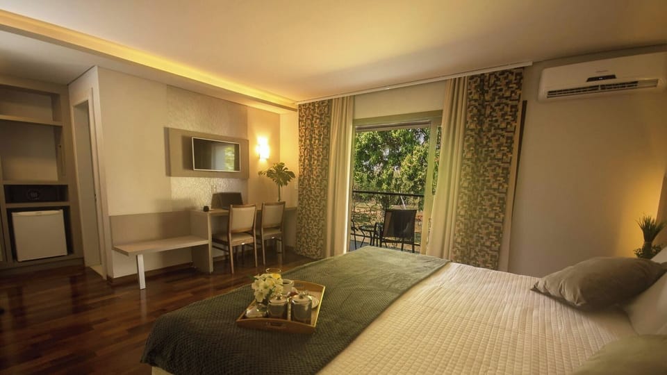 Unwind in a spacious room with balcony views and warm lighting