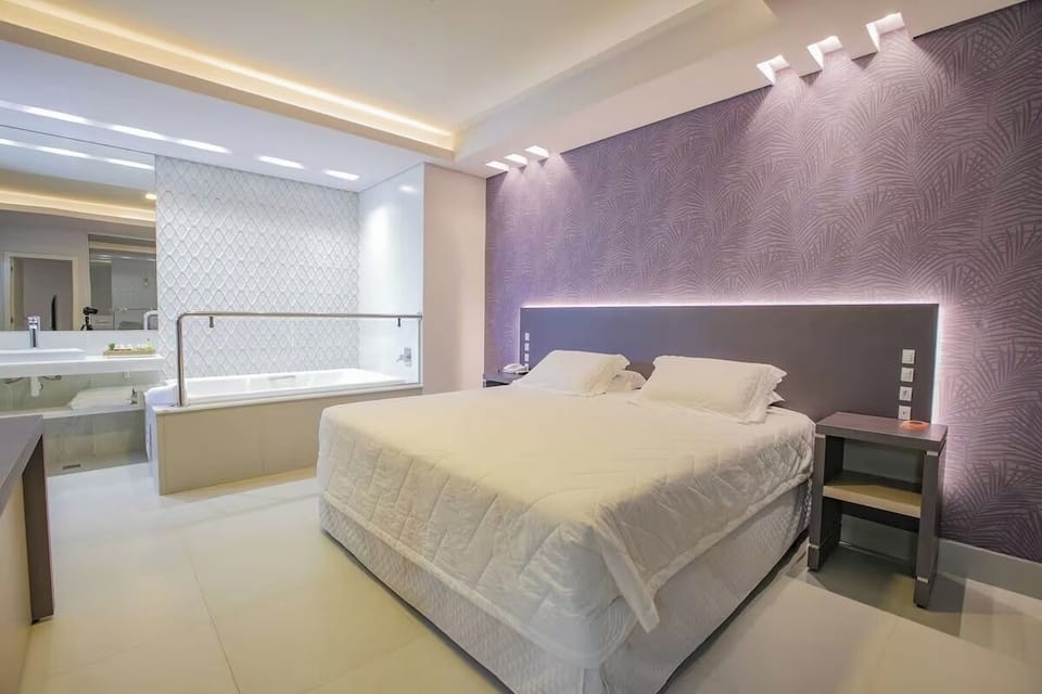 Unwind in a sleek suite with glowing headboard ambiance.