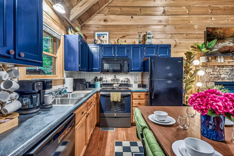 Cozy cabin kitchen with bold blue cabinets and warm wood interiors