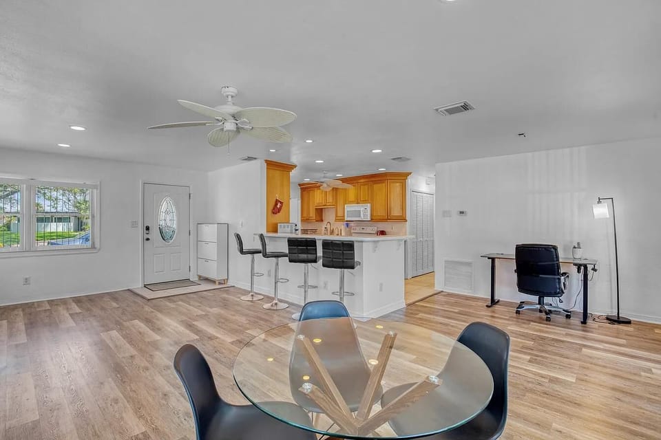 Open-concept living with dining, bar seating & workspace — bright and inviting!