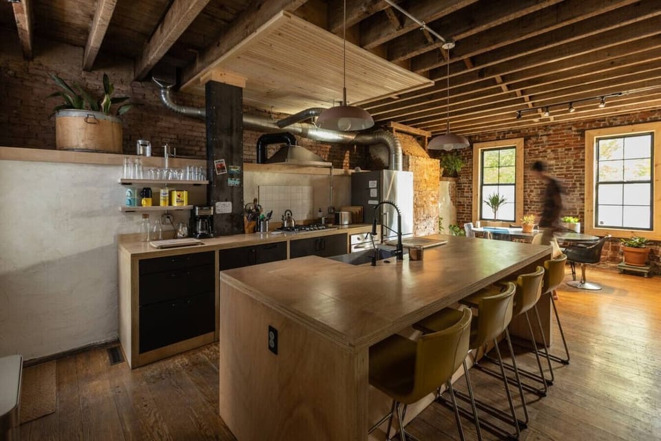 Central open plan kitchen with 4 bar stools, gas stove, coffee maker, toaster and all your kitchen essentials. The dining room sits at the front of the house looking out on our two maple trees in front of the house.