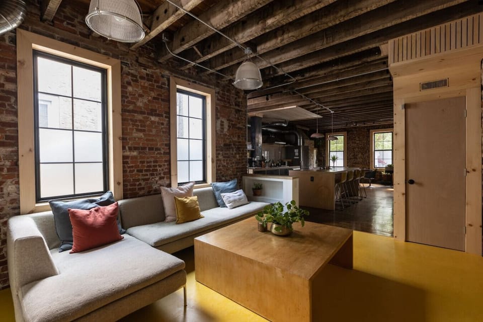 Our 1890s Philly Row House showcases original wood beam ceilings and wood floors throughout the house as well as restored brick walls.