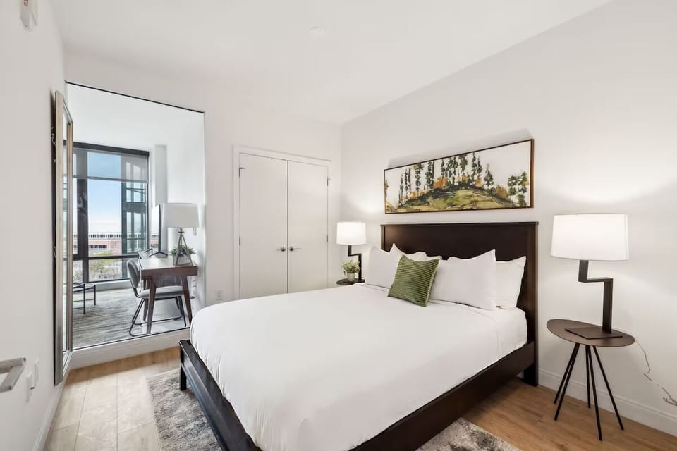 Settle into crisp linens and a calm, minimalist bedroom.