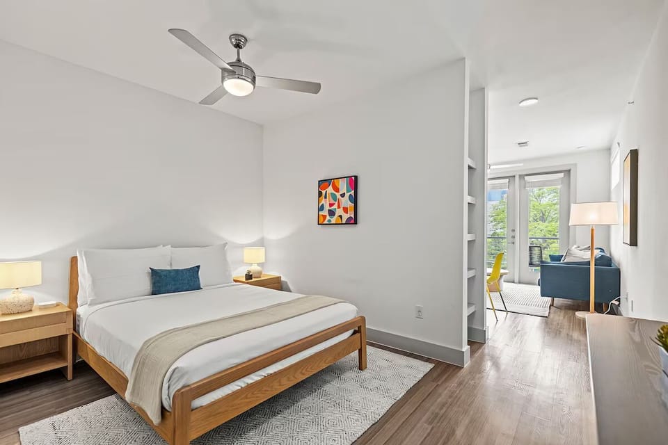 Unwind in crisp linens and airy, sunlit bedroom serenity.